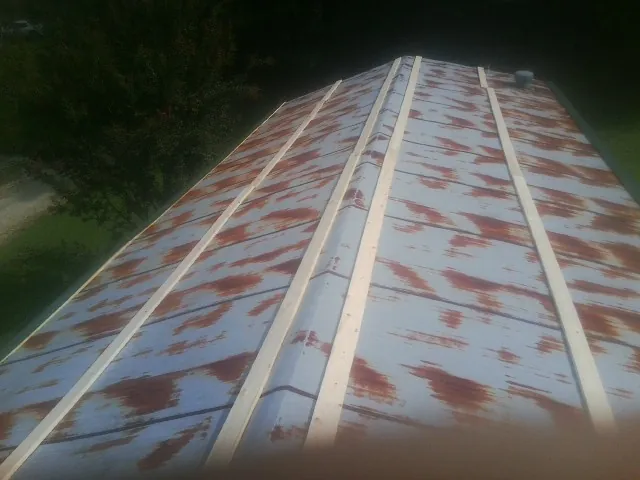 Rusted metal roof panels with new wood purlins before replacement — Storm Damage Roof Repair in Allensville by Roofing Brothers